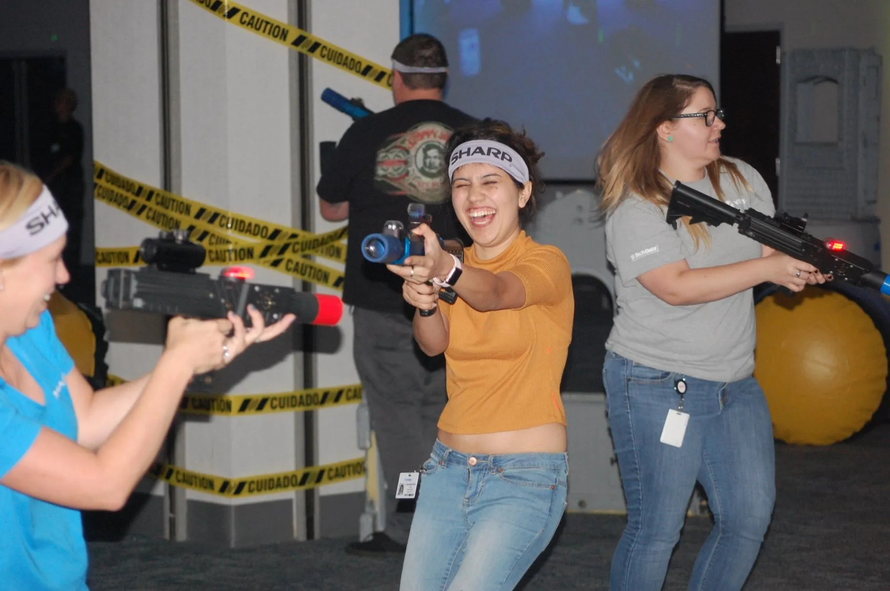Adults laughing while playing indoor laser tag